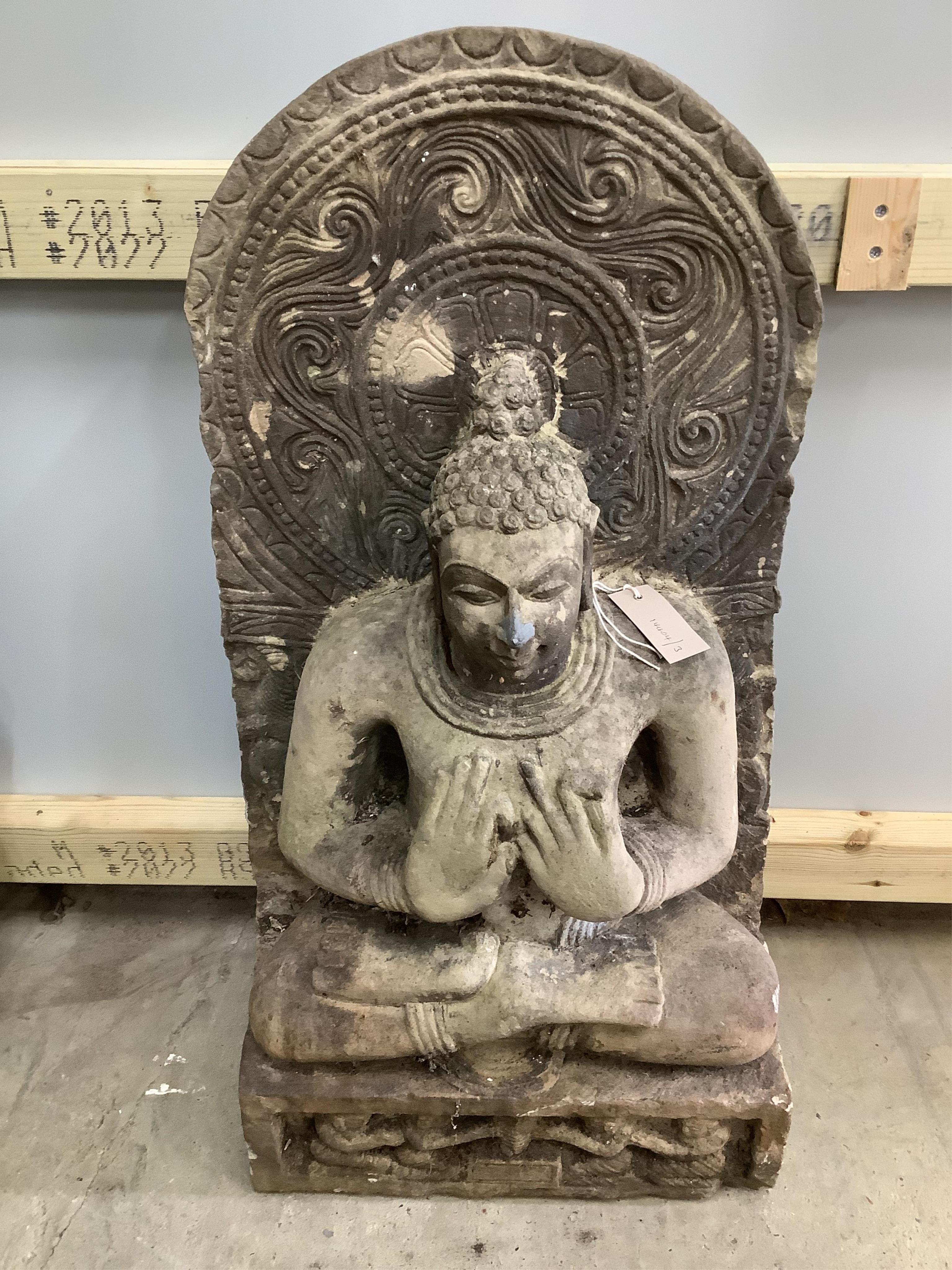 A South East Asian carved stone Buddha, width 39cm, height 79cm. Condition - good